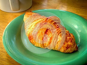 A croissant and a cup of coffee